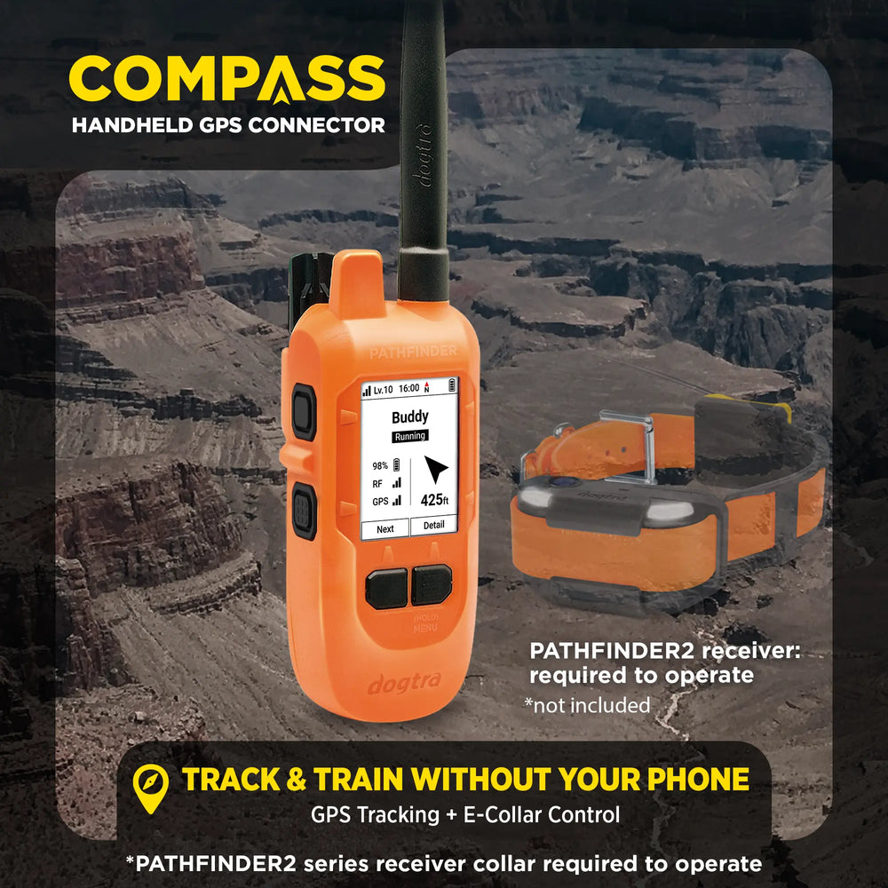 Orange handheld GPS connector with e-collar required to operate on a desert landscape background